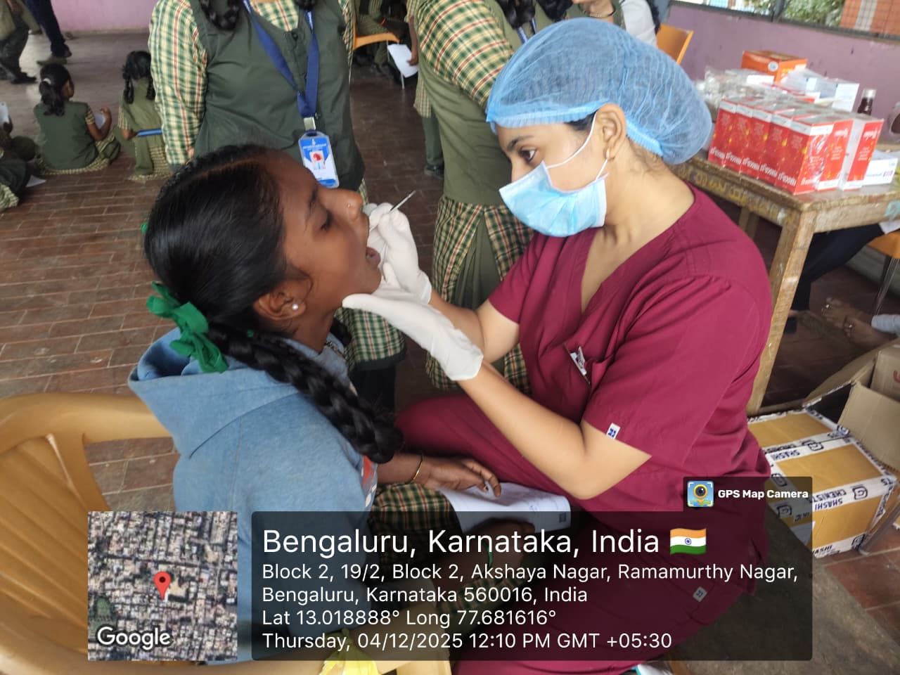 Another female dentist performing a dental screening